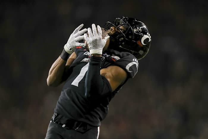 Oct 8, 2021; Cincinnati, Ohio, USA; Cincinnati Bearcats cornerback Coby Bryant (7) intercepts the ball against the Temple Owls in the second half at Nippert Stadium. Mandatory Credit: Katie Stratman-USA TODAY Sports